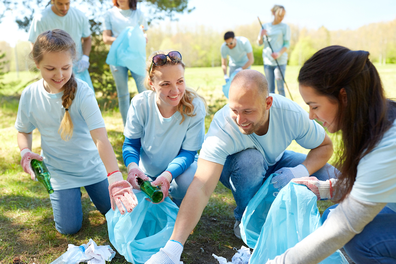 Volunteers Cleaning Trash in a Park While Volunteering for a Non-profit Organization in Nokomis Florida Volunteers Cleaning Trash in a Park While Volunteering for a Non-profit Organization in Nokomis Florida